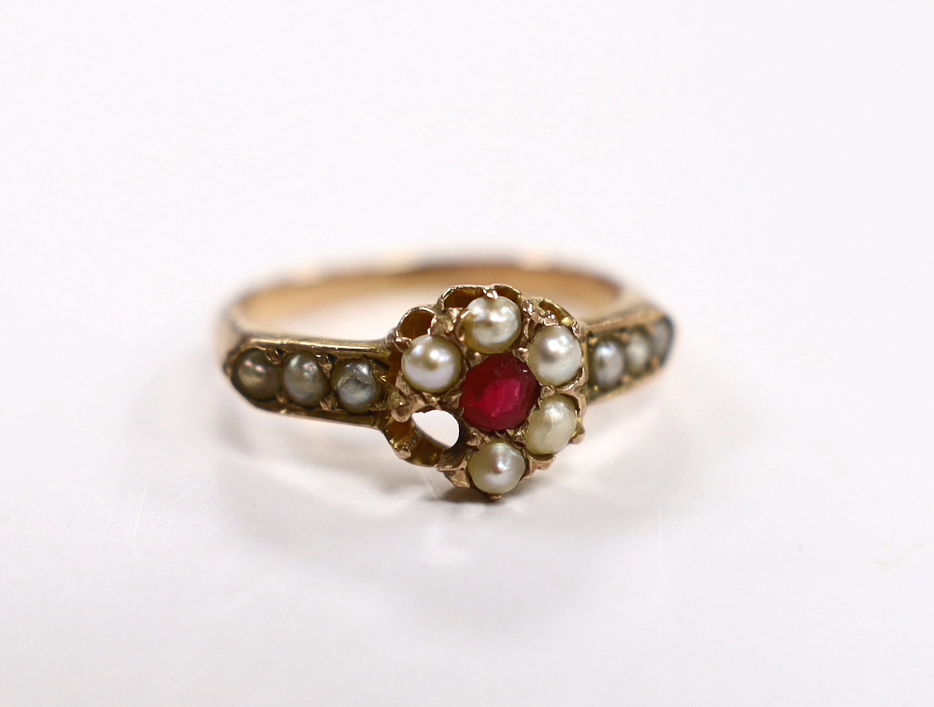 A yellow metal, red paste and split pearl cluster set ring, size O, gross weight 3 grams (one pearl missing).